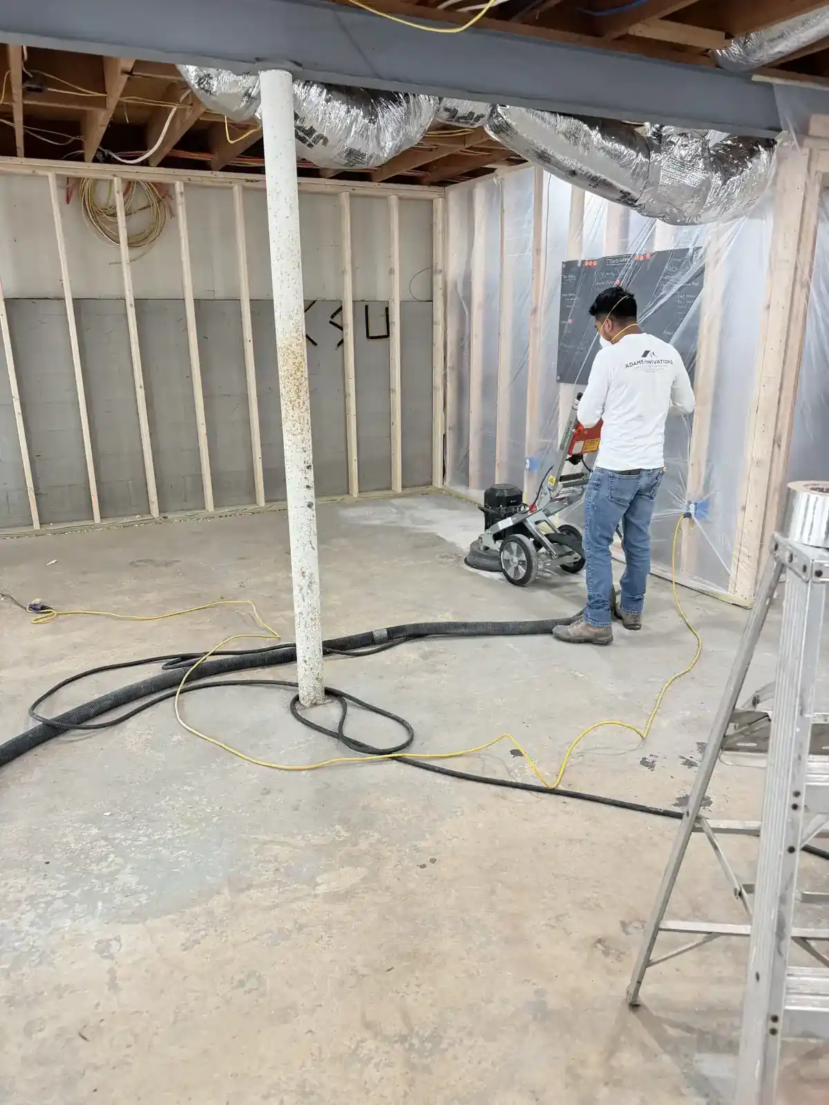 Technician grinding concrete surface